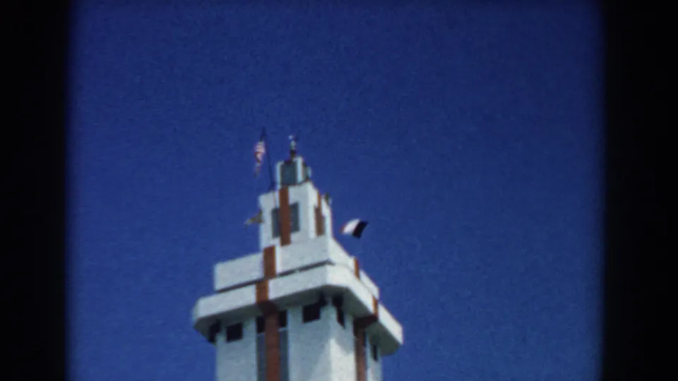 Final 1958 South Carolina frame holding on the upper portion of the white tower or monument against a saturated blue sky.
