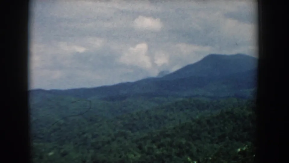 1958 South Carolina landscape frame with a distant mountain ridge, wooded valley, and visible 8mm softness and grain.