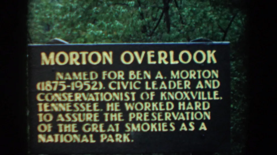 Readable Morton Overlook sign in Tennessee honoring Ben A. Morton, framed by trees in a 1958 8mm home movie.