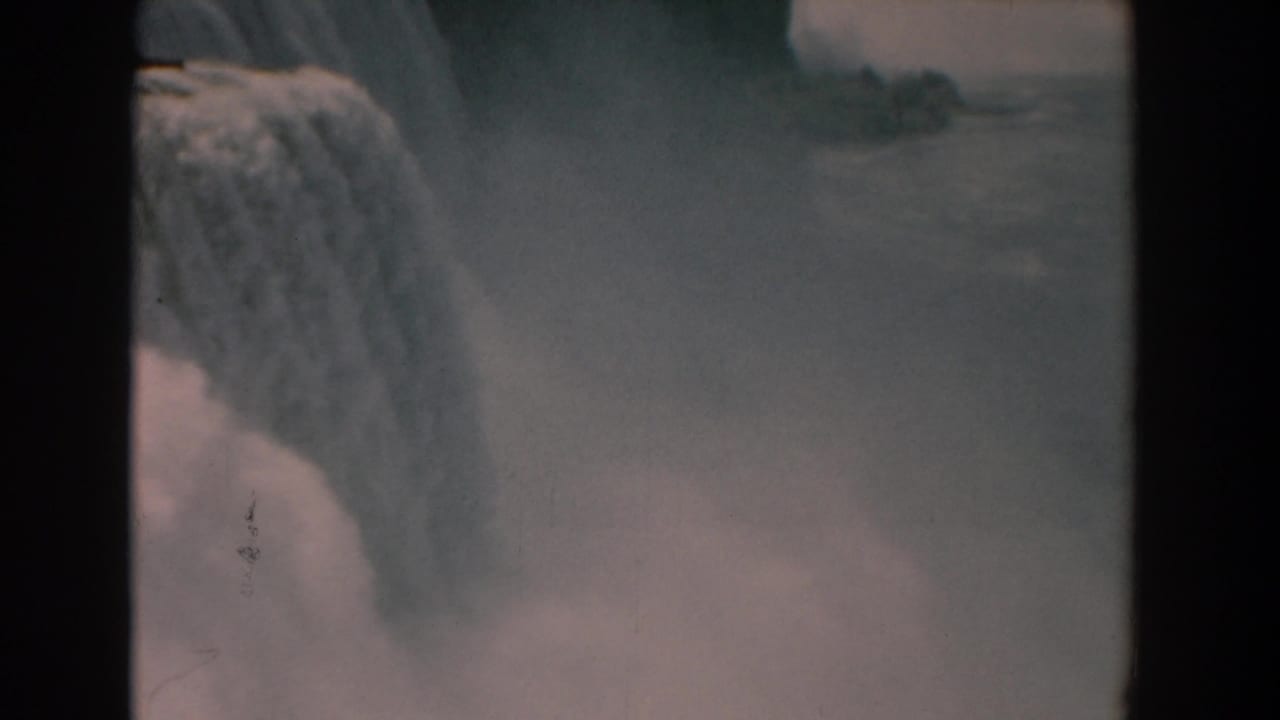 American Falls with water dropping into mist, bordered by dark 8mm film edges.