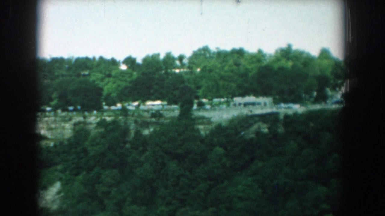 1958 Yorktown, Virginia 8mm frame showing a distant tree-lined river or waterway with dark gate borders and soft archival color.