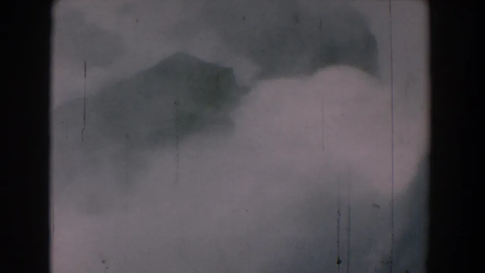 1958 8mm Yorktown, Virginia footage showing misty whitewater around dark rock forms with scratches and muted color.