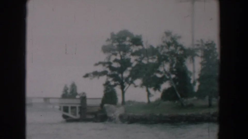 The final Yorktown frame emphasizes the riverbank, mature trees, and bridge end in soft, grainy 8mm color.