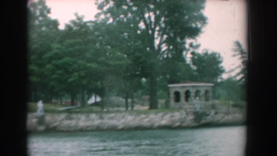 Yorktown waterfront view from 1958, showing water, trees, a stone embankment, a small statue, and an arched shore structure.