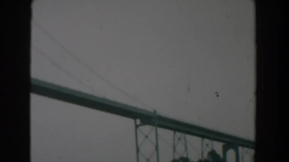 Large green bridge structure near Yorktown, Virginia, framed by dark edges in a soft 8mm home-movie still.