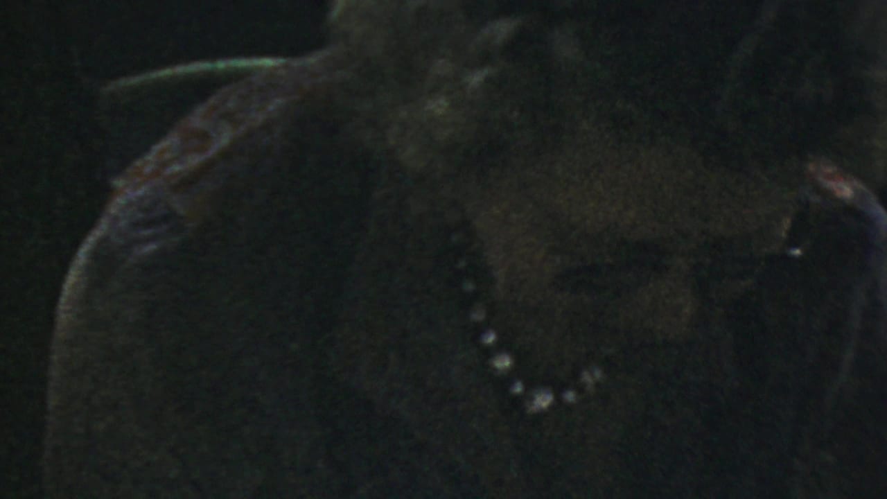 The final frame shows the woman in glasses and a pearl necklace with a slightly widened, attentive expression.