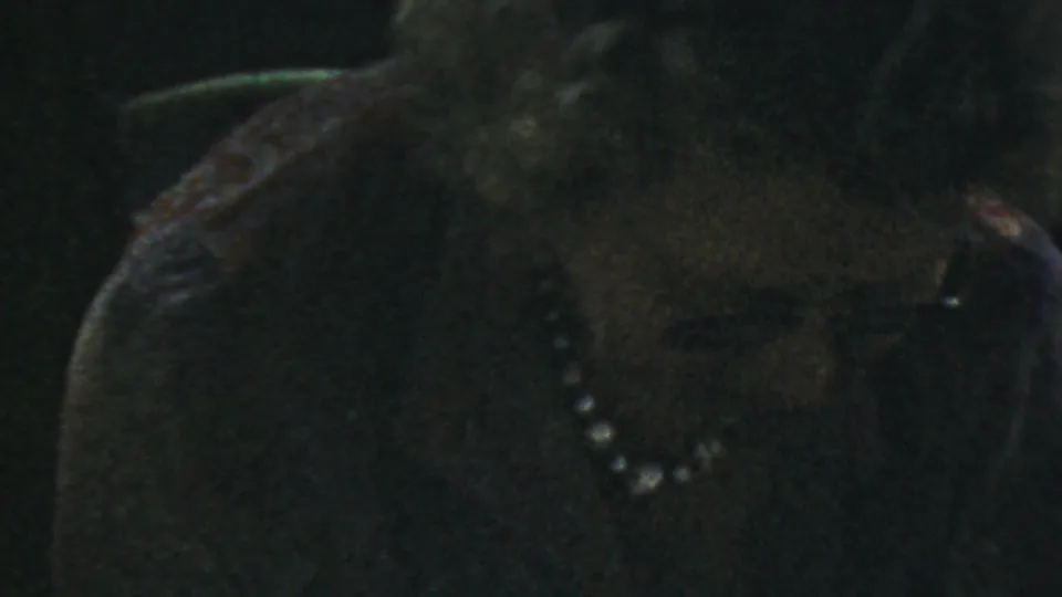 The final frame shows the woman in glasses and a pearl necklace with a slightly widened, attentive expression.