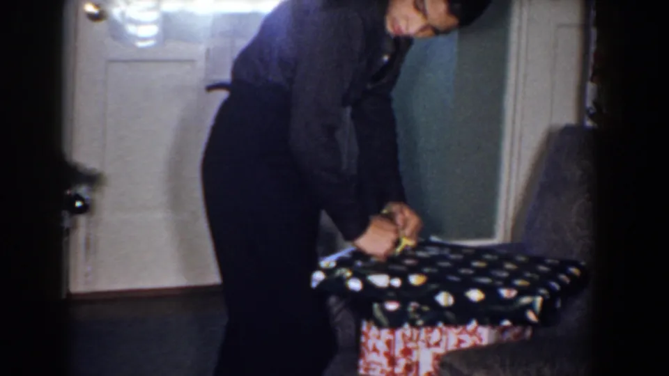 The final frame shows a cropped person bending near a patterned cushioned seat beside a door, likely inside the same private home.