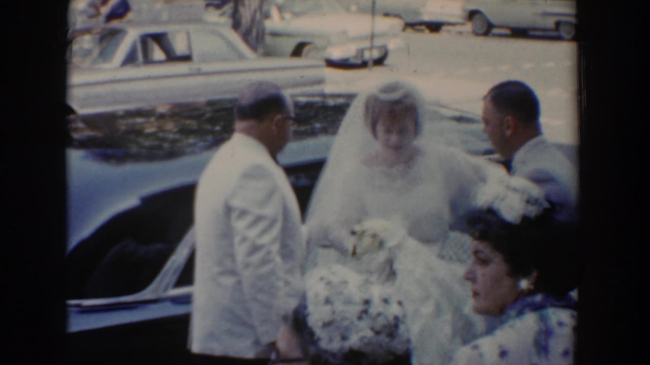 In Bel Air, Maryland, a 1960 bride in a veil steps from a car with men in formal attire nearby.