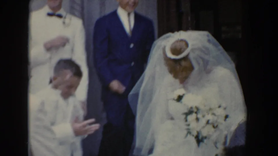 1960 Bel Air, Maryland wedding scene with bride holding flowers, groom in white jacket, and a suited guest near the church entrance.