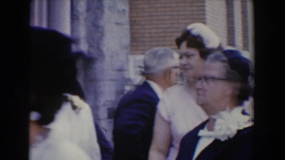 Guests in formal dress cluster outside the Bel Air, Maryland building, including a foreground woman in dark formalwear and men in suits.