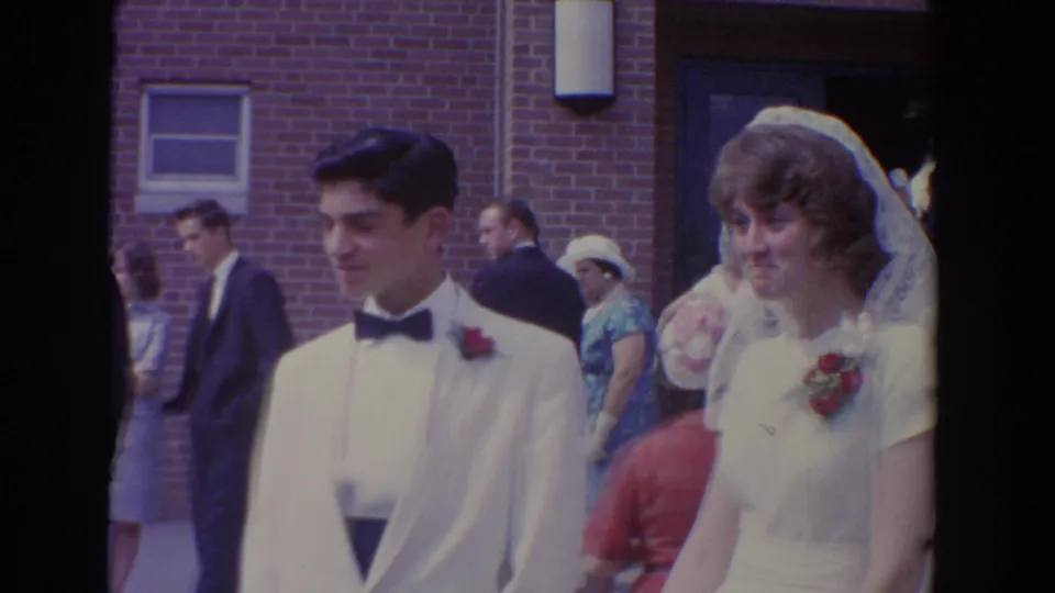 Bride and groom walk together outside the Bel Air, Maryland church during a 1960 wedding home movie.
