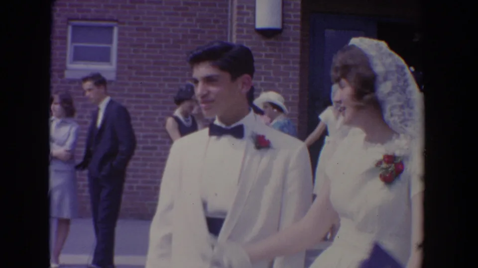 The young couple smiles while walking together outside the Bel Air church after the wedding ceremony.