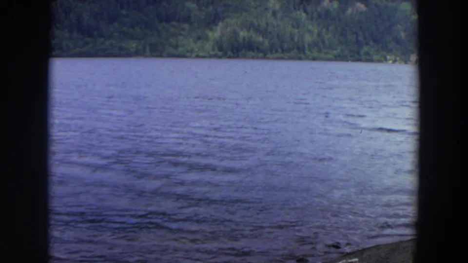 A wide 8mm view shows rippled lake water with forested hills in the background, identified by metadata as Washington.