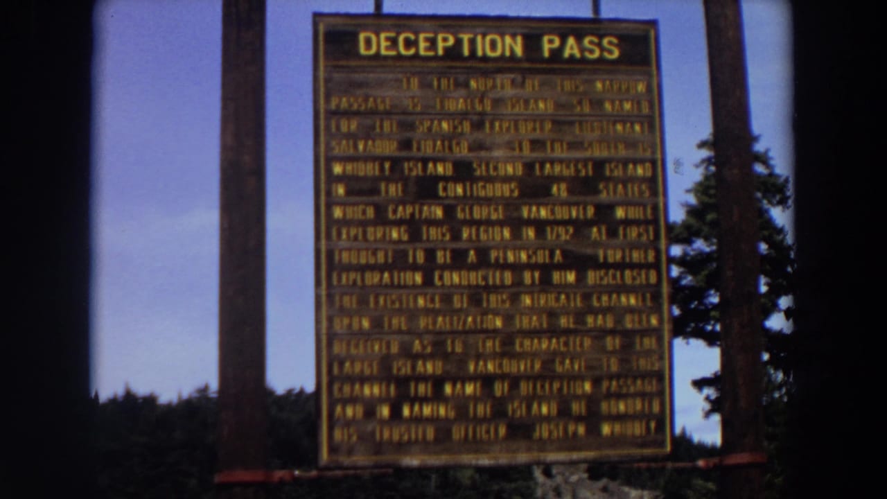 The final frame shows the Deception Pass State Park sign more fully, framed by posts with trees and blue sky around it.