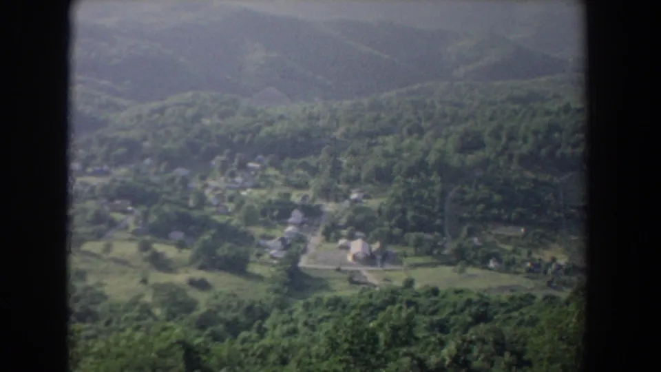 1965 Fallston, Maryland frame of a green valley with scattered homes, fields, dense woods, and soft distant hills.