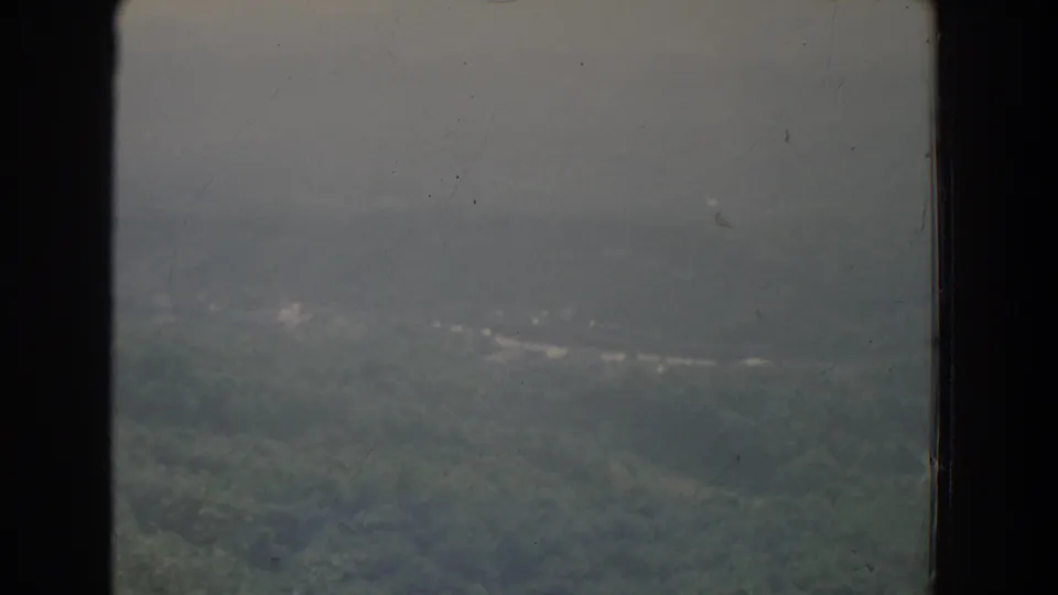 Aerial view of hazy wooded hills near Fallston, Maryland, framed by the aircraft window edge.