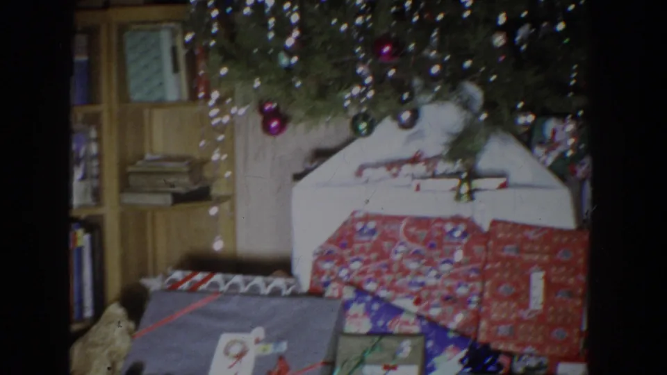 A tinsel-decorated Christmas tree appears above wrapped gifts in a 1965 Fallston, Maryland private home interior.