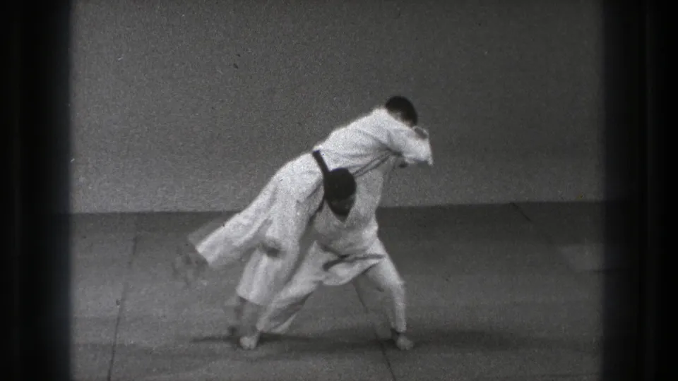 The final frame shows a throw in progress, with one adult man airborne or off balance over the crouched partner in the Tokyo dojo footage.