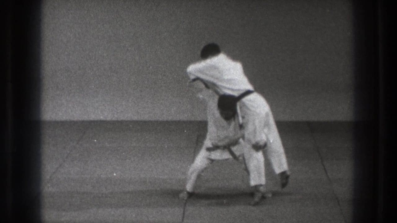 A black-belt martial artist appears to lift his partner during a karate throw demonstration in Tokyo, Japan, 1971 footage.