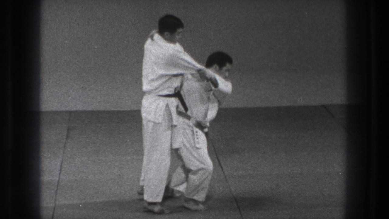 The final frame shows the black-belt practitioner applying control while the other man bends low during the karate technique.