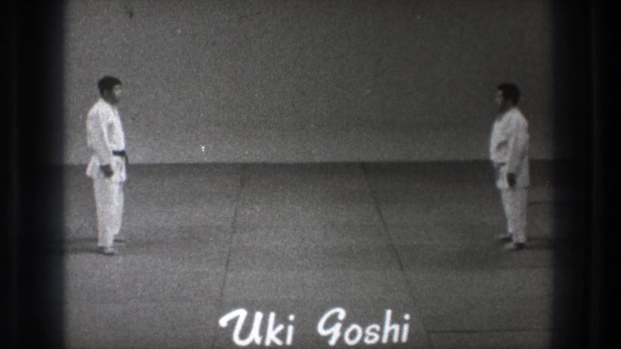 1971 Tokyo frame with two black-belt martial artists facing each other and the handwritten label 'Uki Goshi' near the lower edge.