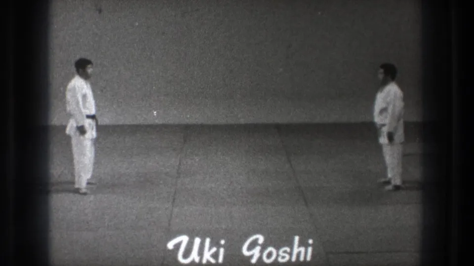 1971 Tokyo frame with two black-belt martial artists facing each other and the handwritten label 'Uki Goshi' near the lower edge.