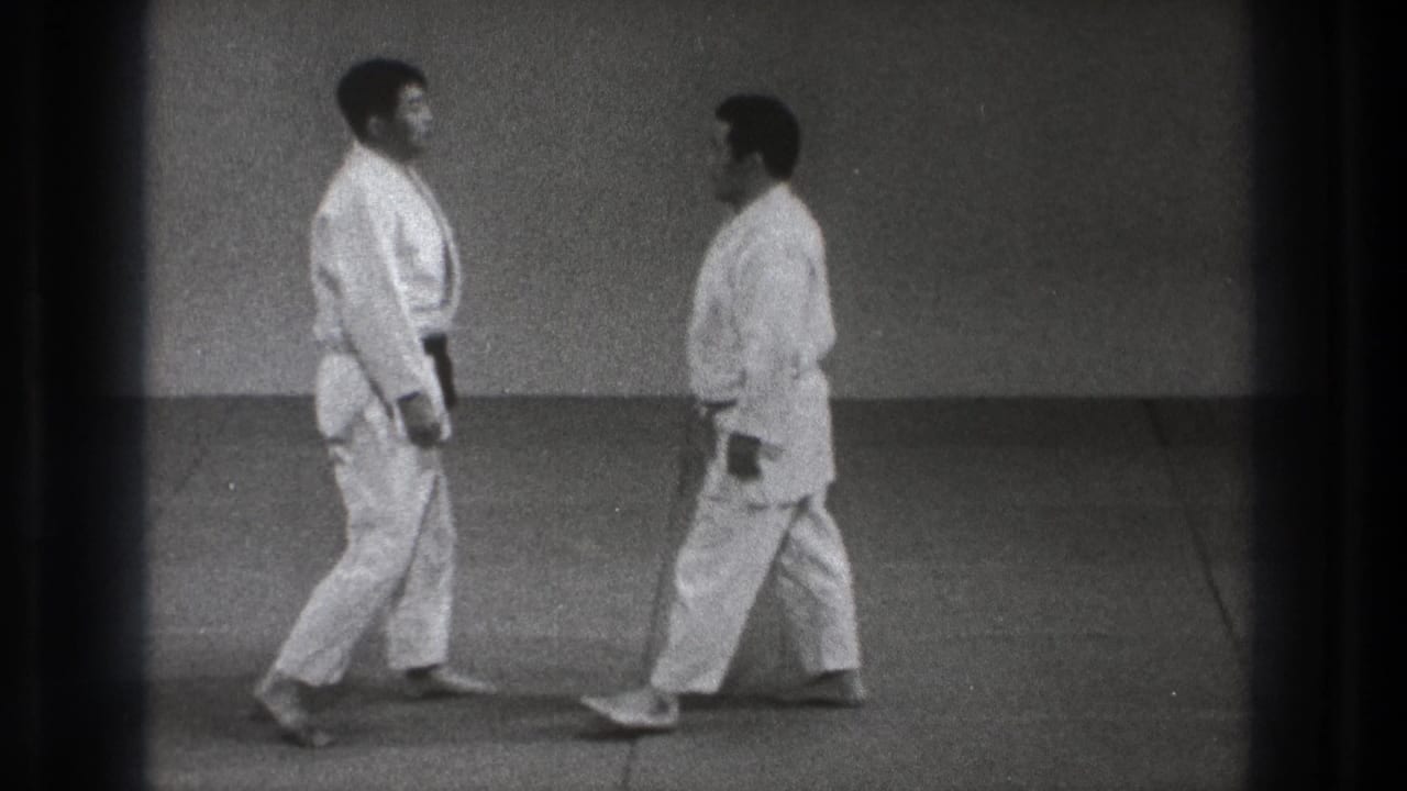 The clip ends with the two adult practitioners facing each other on the mat in the 1971 Tokyo martial arts setting.