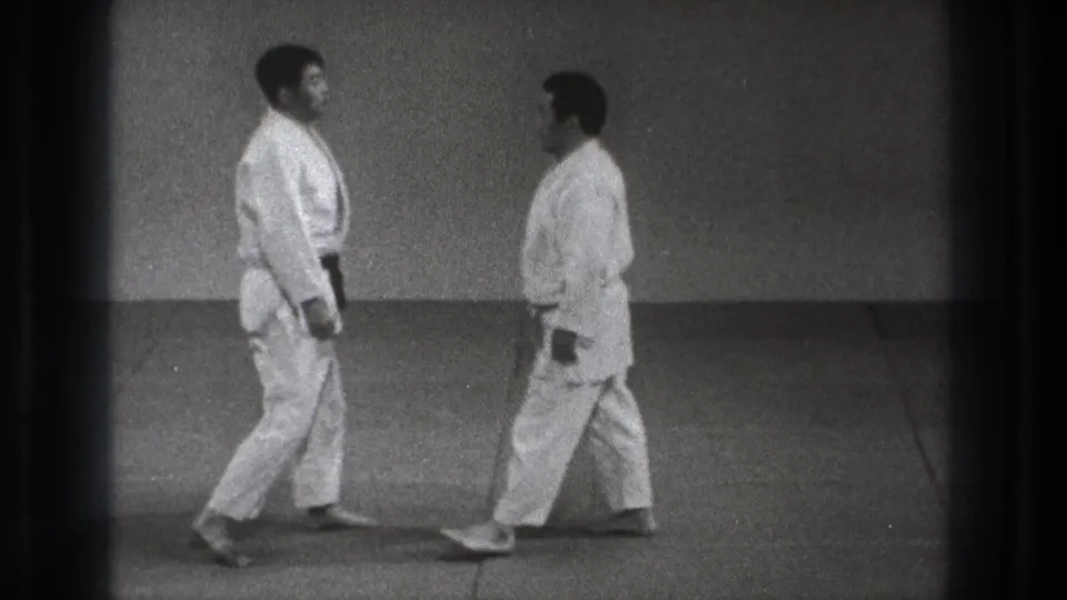The clip ends with the two adult practitioners facing each other on the mat in the 1971 Tokyo martial arts setting.