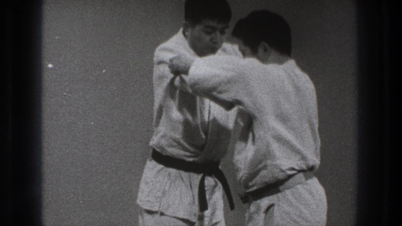The 1971 Tokyo clip shows two adult karate practitioners in white gi working through a close grappling movement.