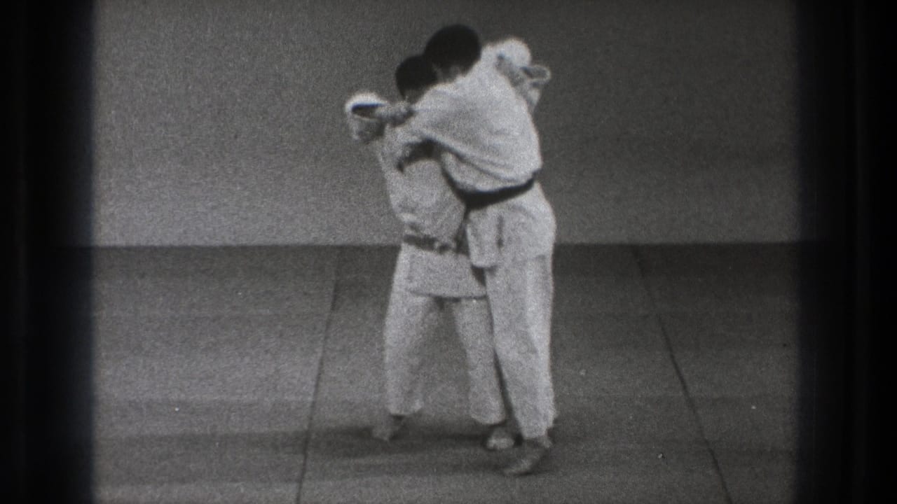 The final frame shows the two karate practitioners in a tight hold or finishing position during the 1971 Tokyo dojo demonstration.