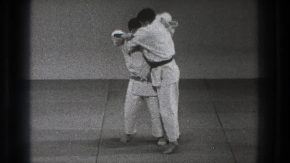 The final frame shows the two karate practitioners in a tight hold or finishing position during the 1971 Tokyo dojo demonstration.