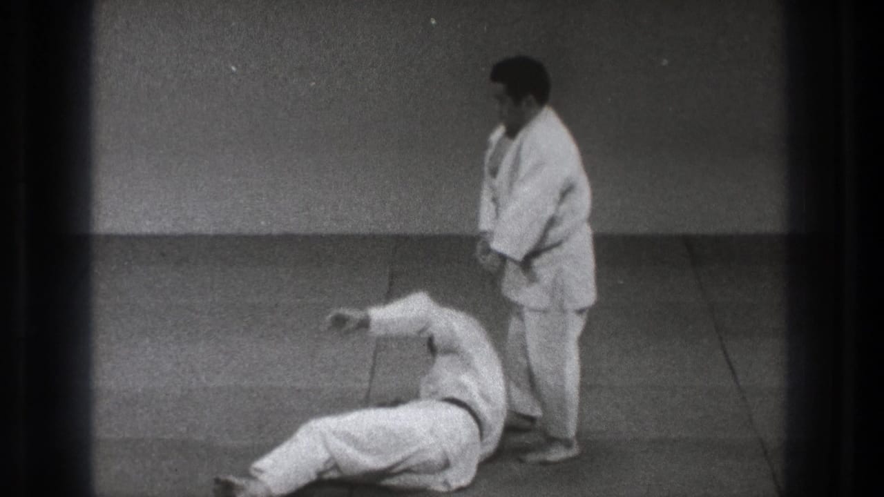 Tokyo 1971 8mm footage shows one gi-clad practitioner standing beside another lying on the mat after a throw.