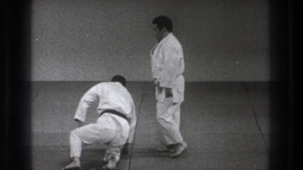Near the end of the Tokyo 1971 demonstration, one practitioner begins to rise as the other stands beside him on the mat.