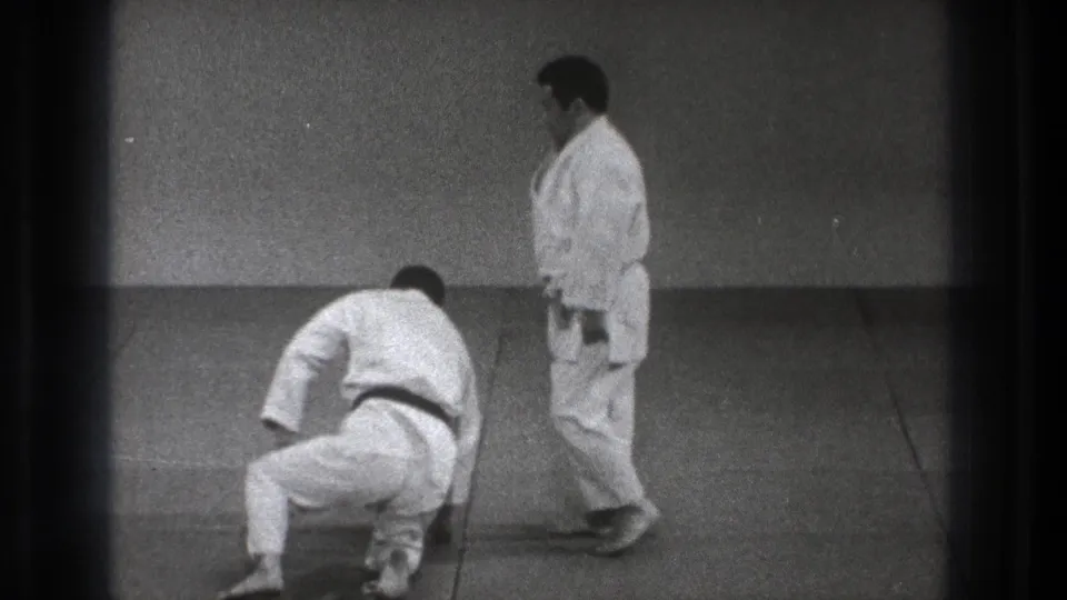 Near the end of the Tokyo 1971 demonstration, one practitioner begins to rise as the other stands beside him on the mat.
