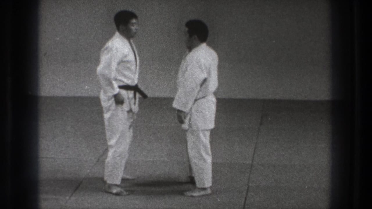 In the Tokyo judo scene, the two uniformed men stand close together on the mat before contact.