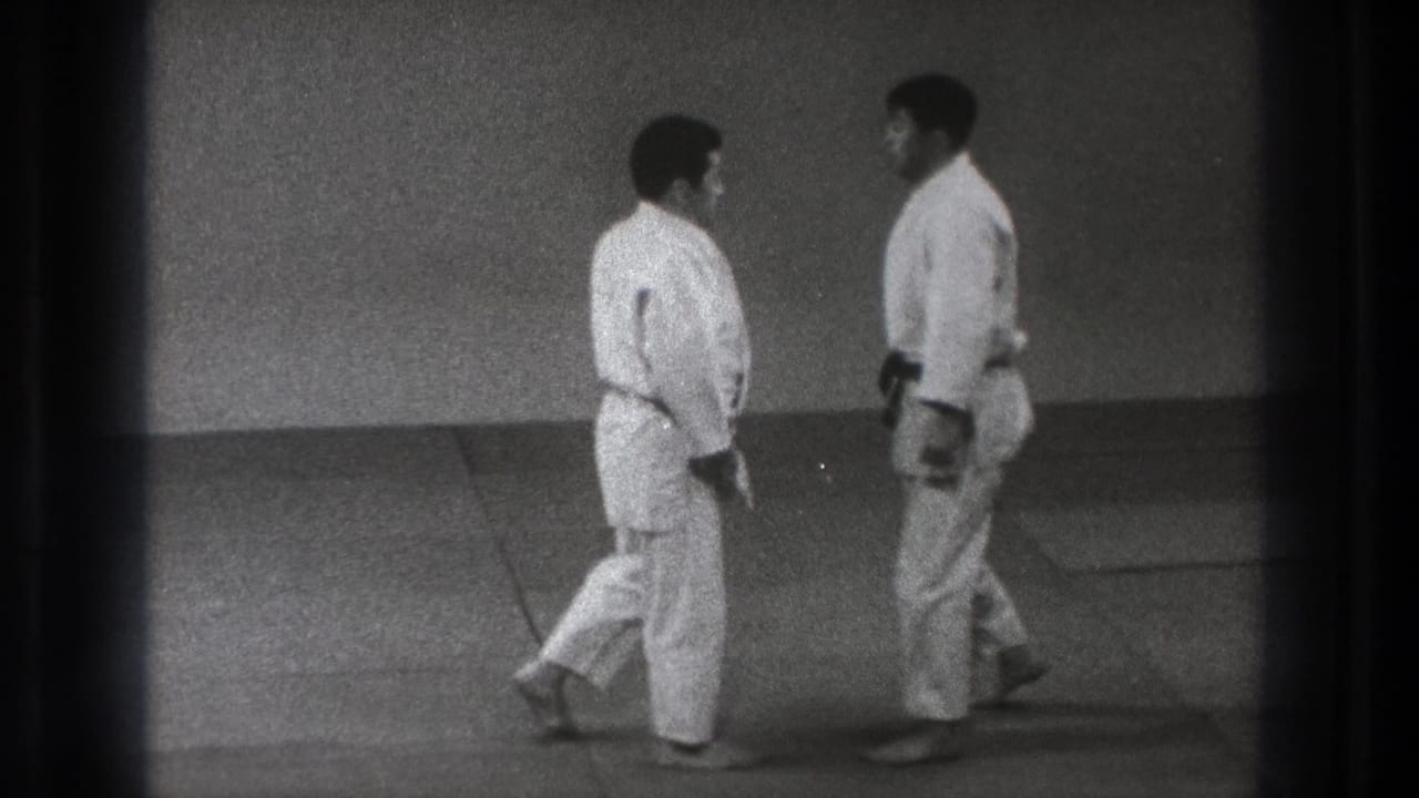 In 1971 Tokyo home-movie footage, two men in white judo uniforms face each other on a dojo mat.