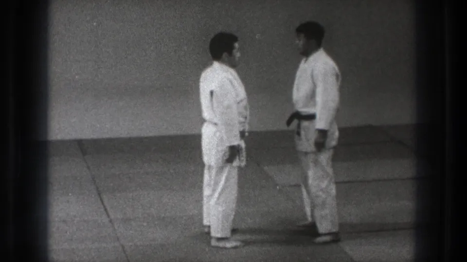 The 1971 Tokyo judo footage shows two practitioners facing each other in a quiet dojo setting.
