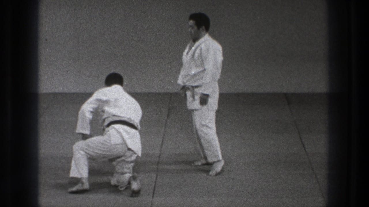 In the final frame, one judo practitioner kneels or rises from the mat while the other stands in a plain Tokyo training hall setting.