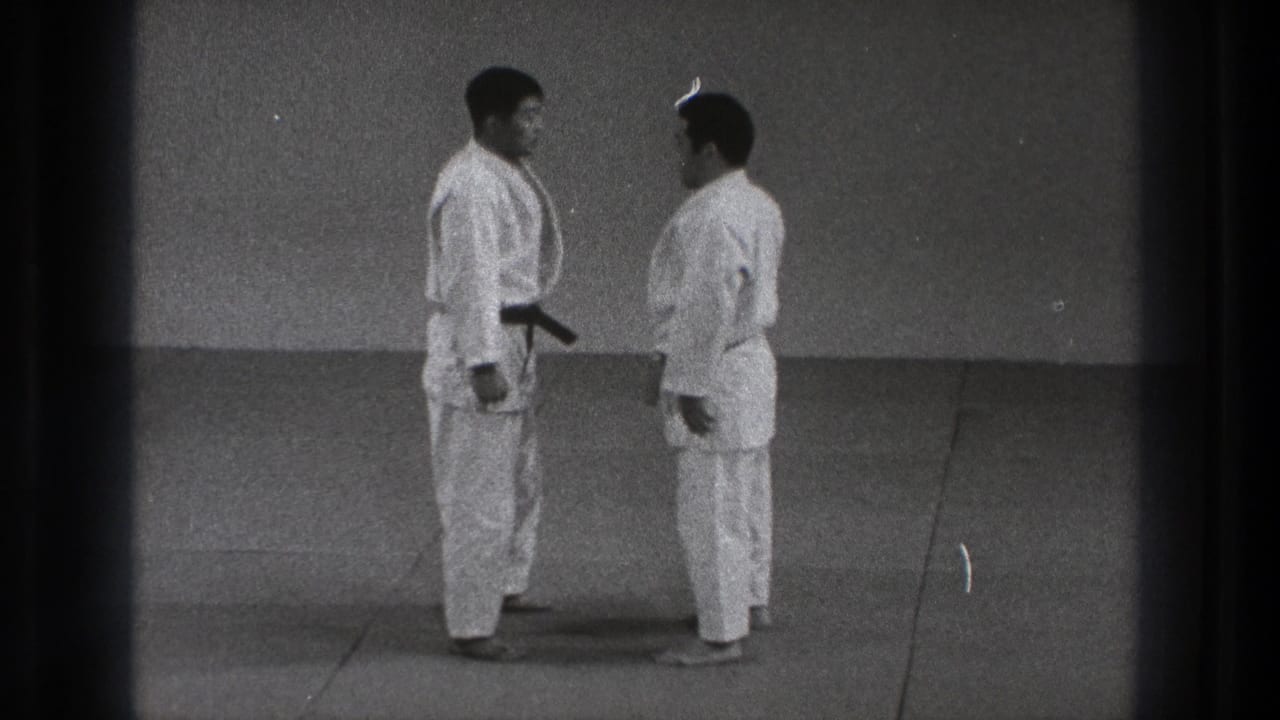 In the 1971 Tokyo footage, two men in judogi stand close on the mat before beginning contact.
