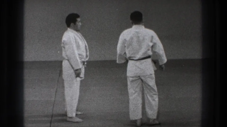 At the end of the short 1971 Tokyo sequence, the two men face each other on the mat after resetting the exercise.