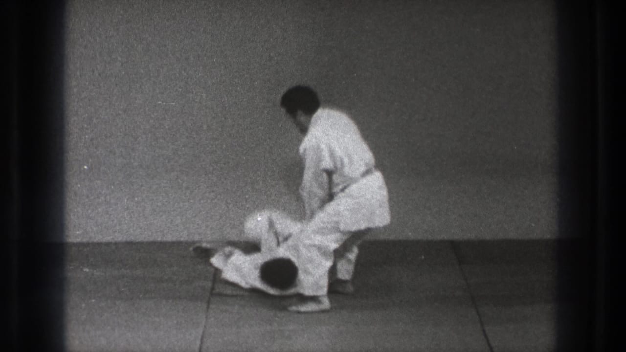 The final frame shows one adult man in a white gi standing over his partner on the mat after the throw in Tokyo 1971 footage.