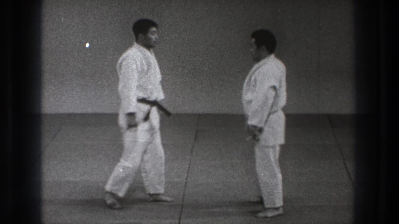 In the final frame, two adult practitioners in white gi stand face to face on mats in the simple 1971 Tokyo dojo scene.