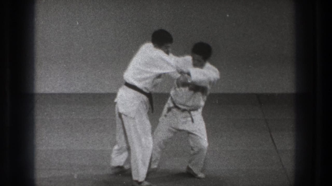 The 1971 Tokyo frame shows a controlled judo hip-toss setup, with one man crouched and the other maintaining grip.