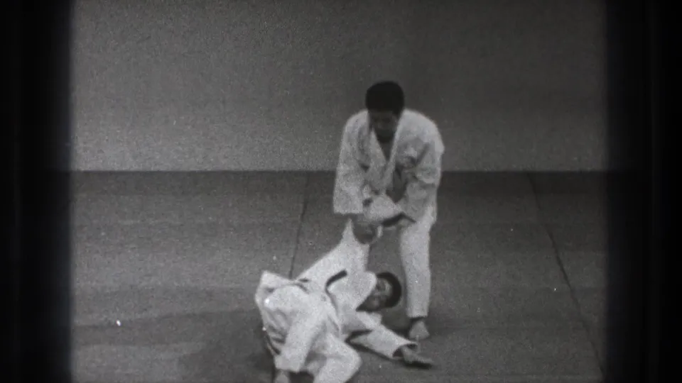 The final 1971 Tokyo frame shows the standing practitioner holding his partner's arm as the partner lies on the dojo mat.