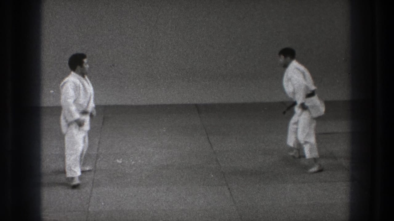 1971 Tokyo 8mm frame showing two martial artists in white gi facing each other after resetting on the mat.