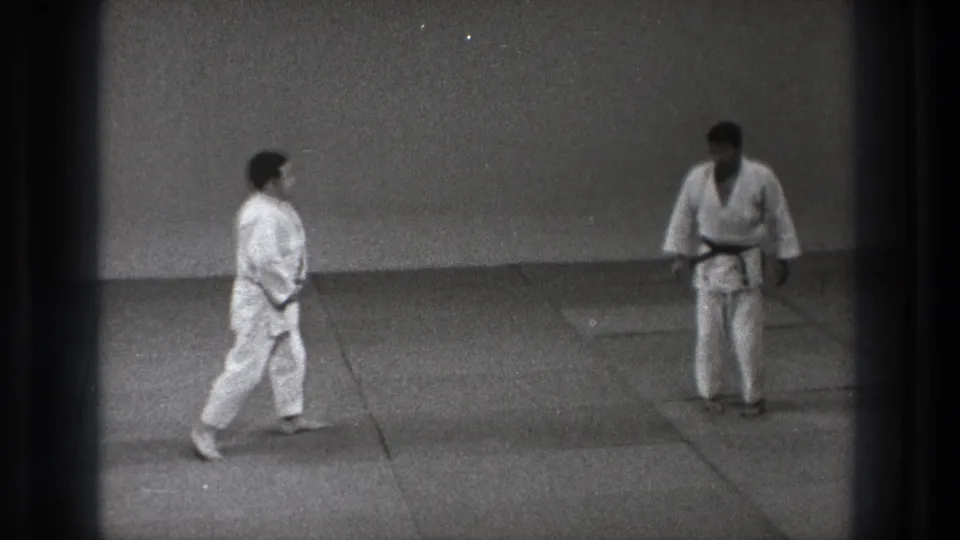 The two practitioners stand facing each other on mats at the end of the 1971 Tokyo martial arts demonstration.