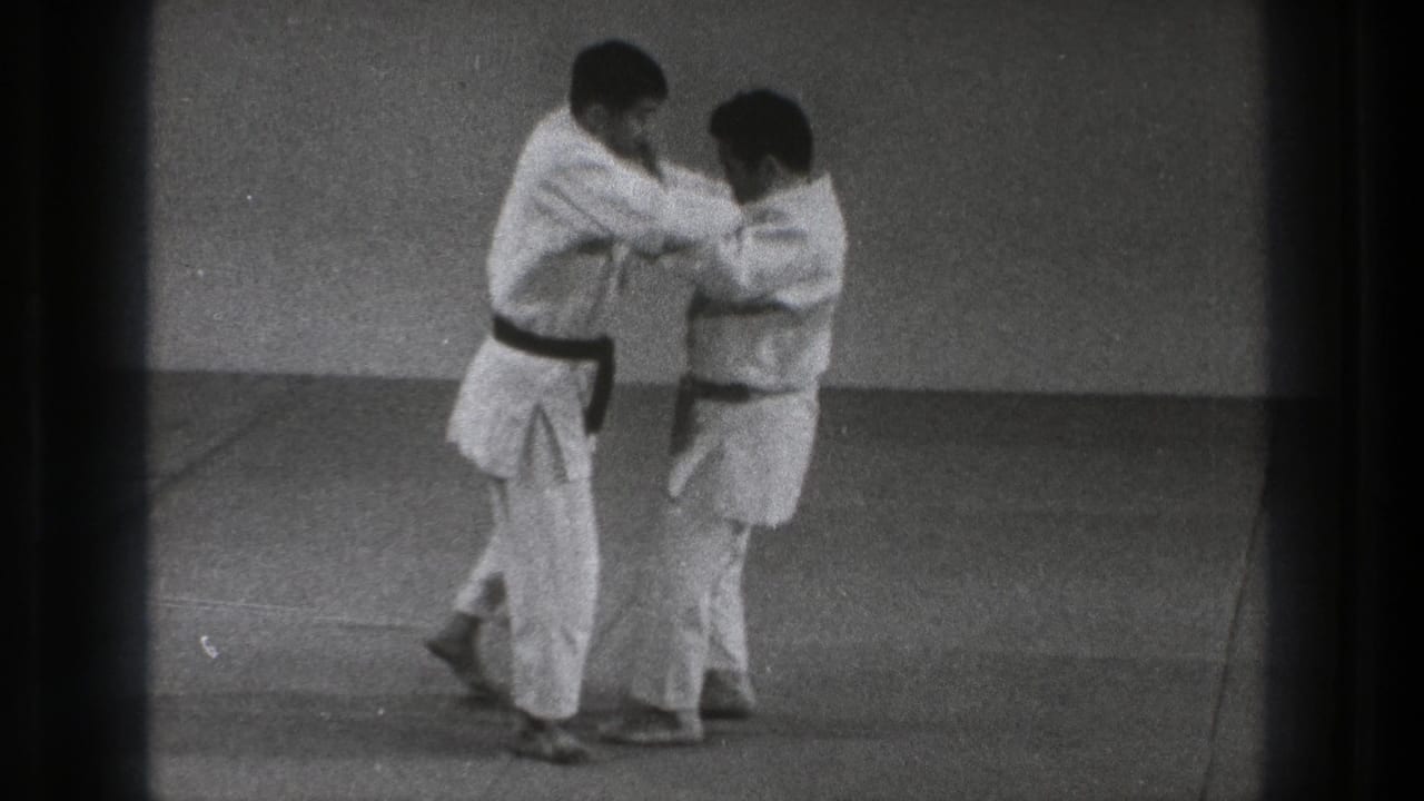 The Tokyo 1971 8mm frame shows two martial artists in white gi closing distance as they continue a grappling drill.