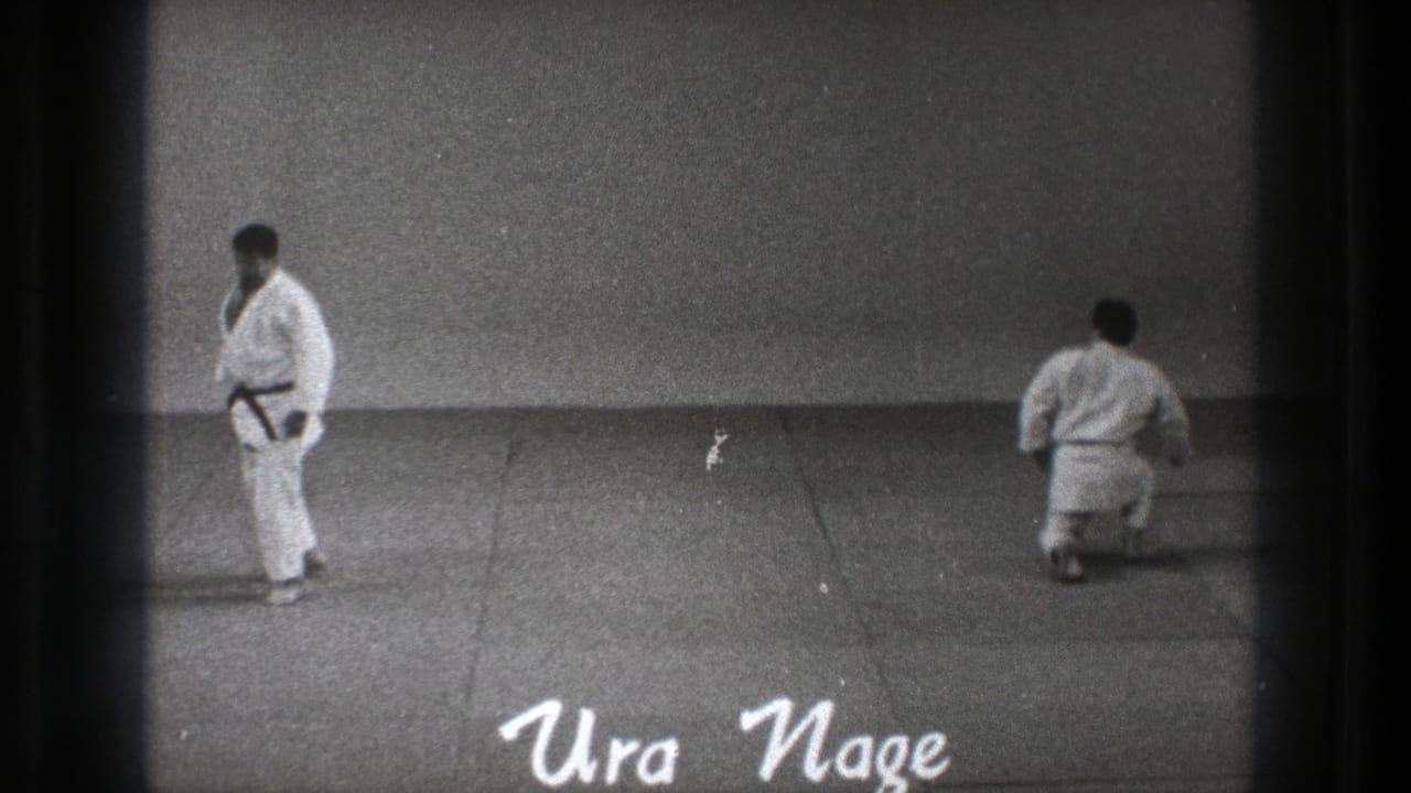 Two judoka on a mat with Ura Nage text at the bottom.