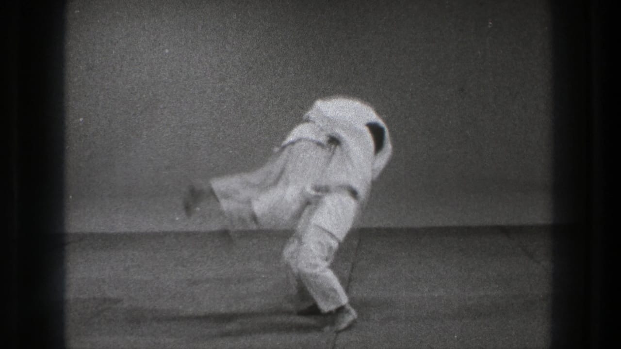 One gi-clad practitioner lifts the other into the air during a throw.